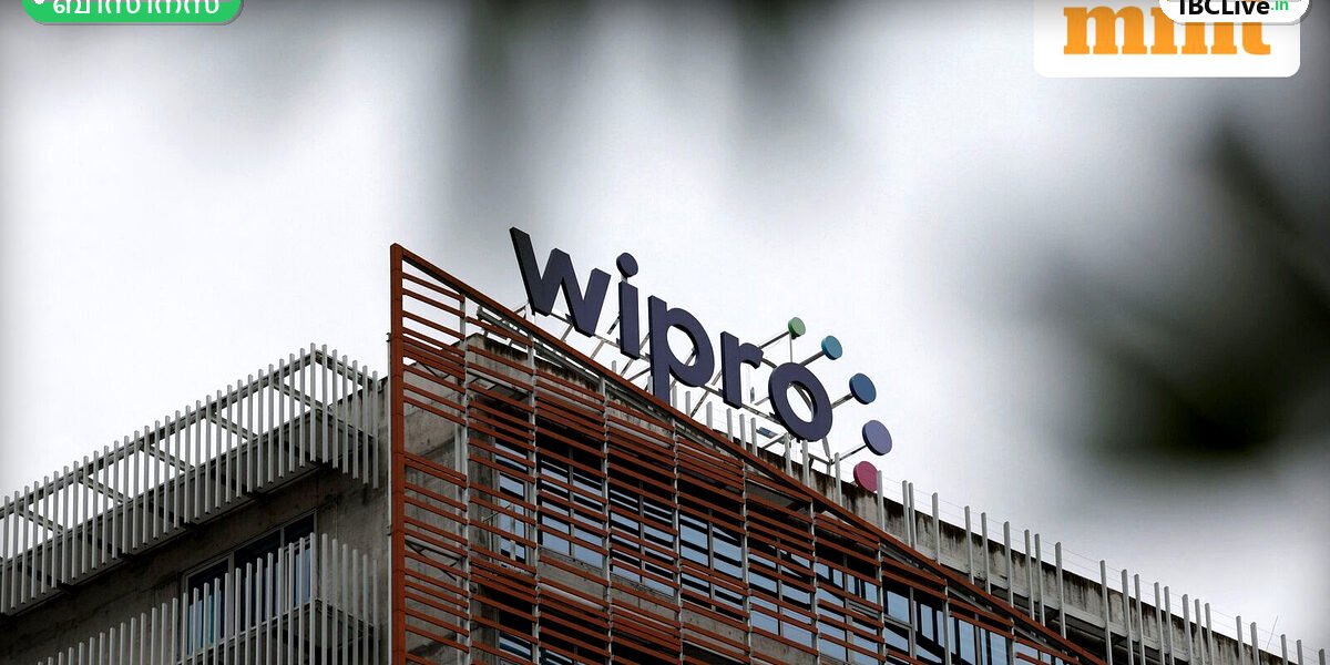 Wipro ലോഗോയും ഓഹരി വിപണിയുടെ ചാർട്ടുകളും കാണിക്കുന്ന ചിത്രം.