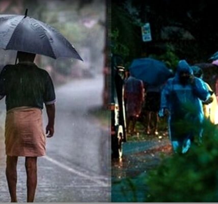 കേരളത്തിൽ ശക്തമായ മഴ പെയ്യുന്ന ഒരു ചിത്രം. റോഡിലൂടെ വാഹനങ്ങൾ പോകുന്നു, ആളുകൾ കുട ചൂടി നടക്കുന്നു.